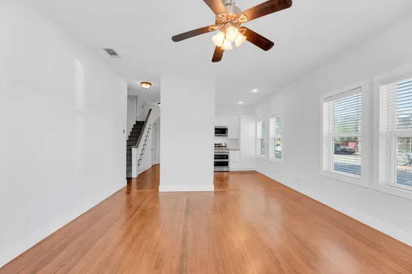 wooden floor in an empty room with a window