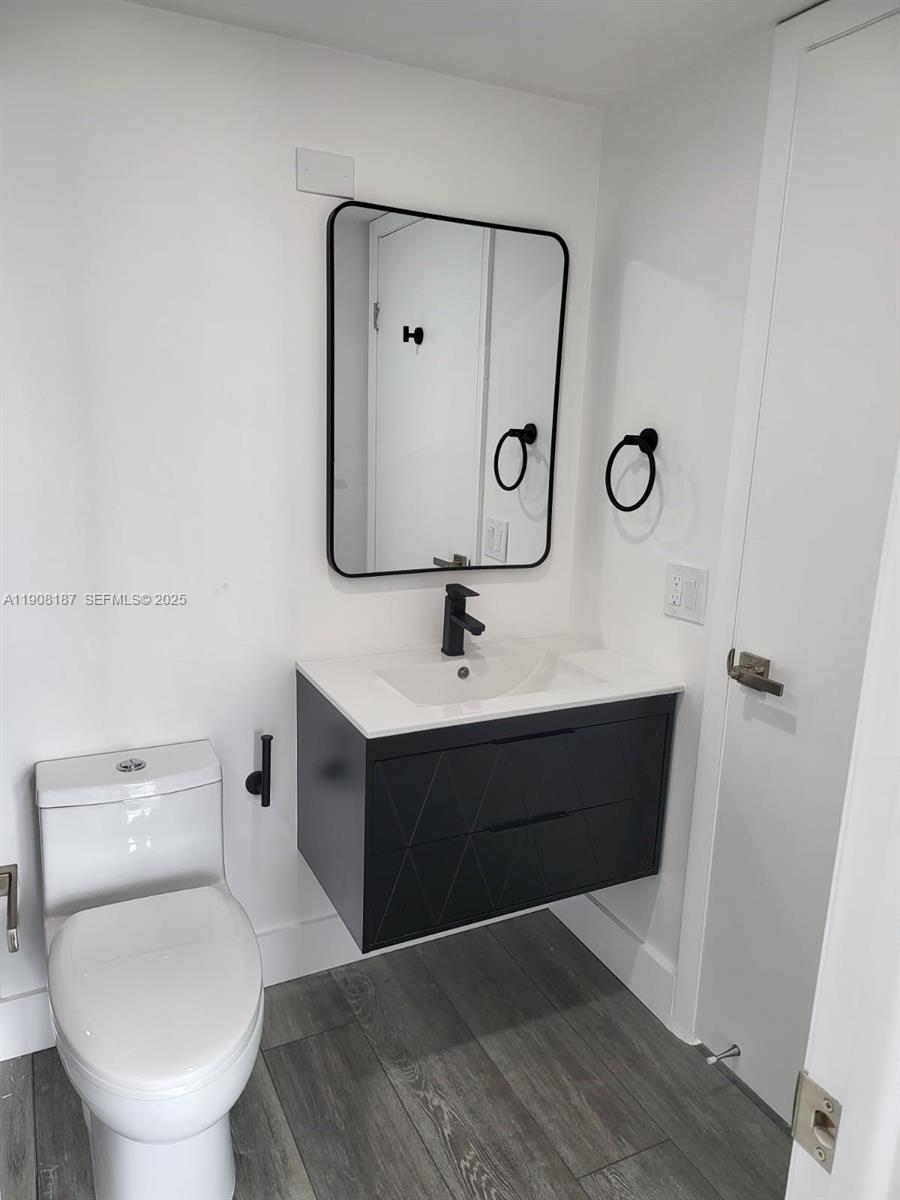 11800 Southwest 18th Street, Unit 5274 Miami, FL 33175 - Photo 7 of 12 a bathroom with a toilet sink and mirror