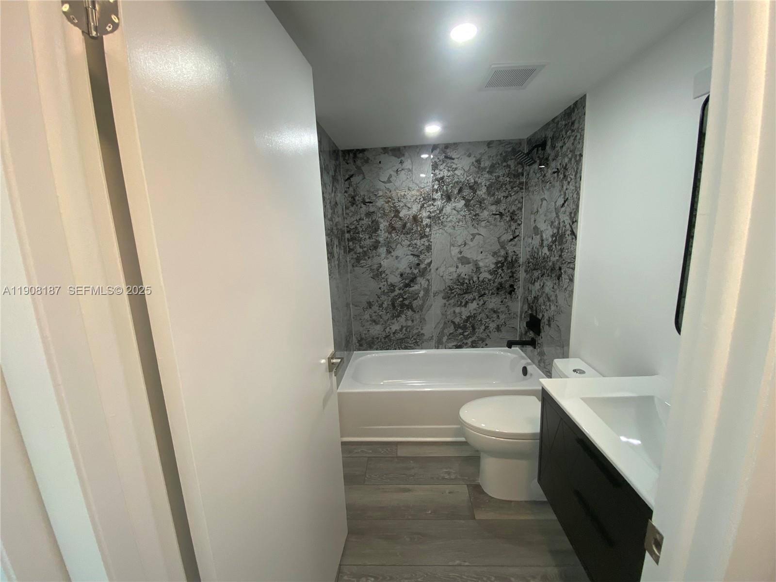 11800 Southwest 18th Street, Unit 5274 Miami, FL 33175 - Photo 9 of 12 a bathroom with a double vanity sink toilet and shower