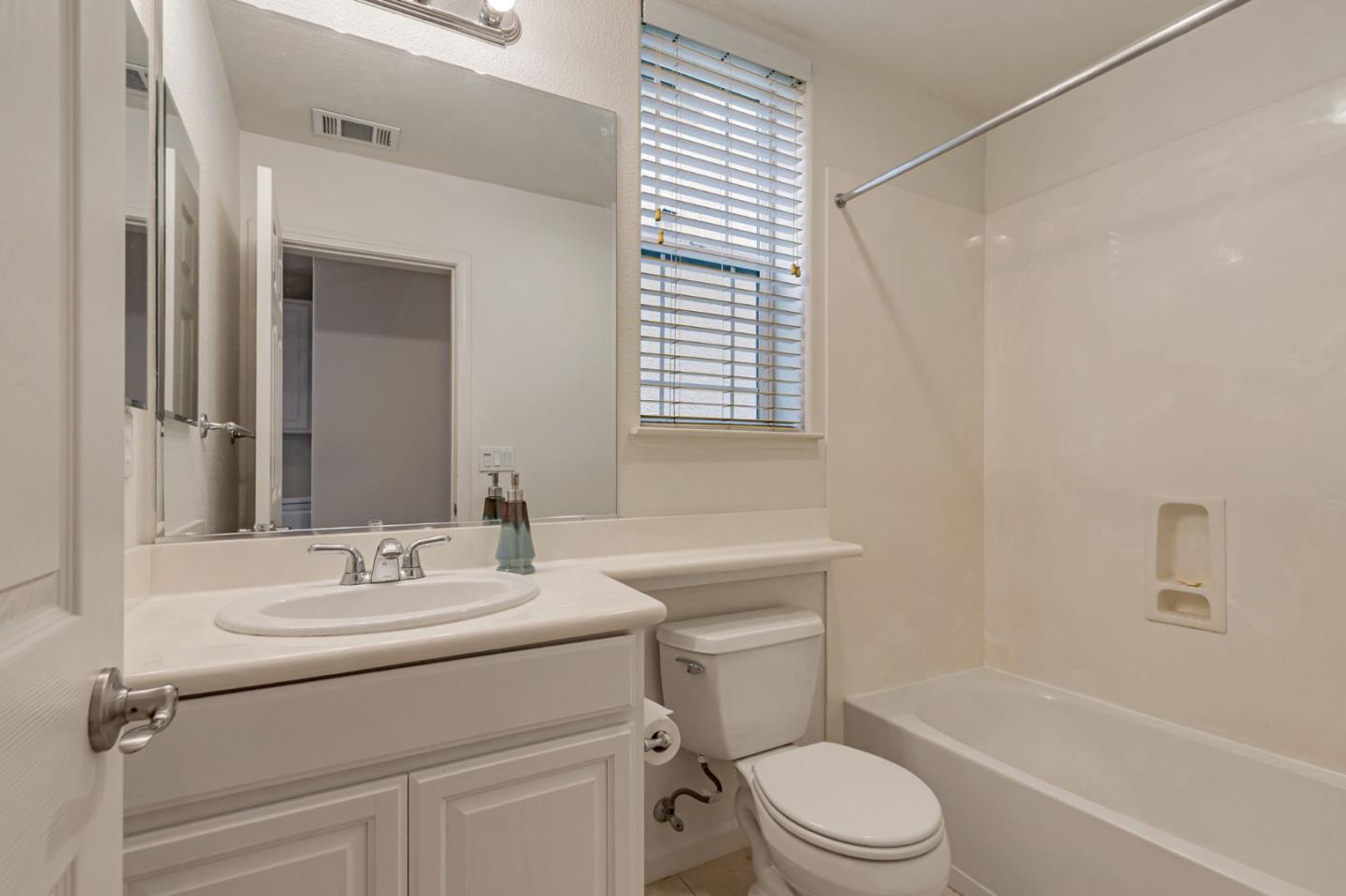 1103 Vida Larga Loop Milpitas, CA 95035 - Photo 29 of 44 a bathroom with a sink toilet vanity and tub