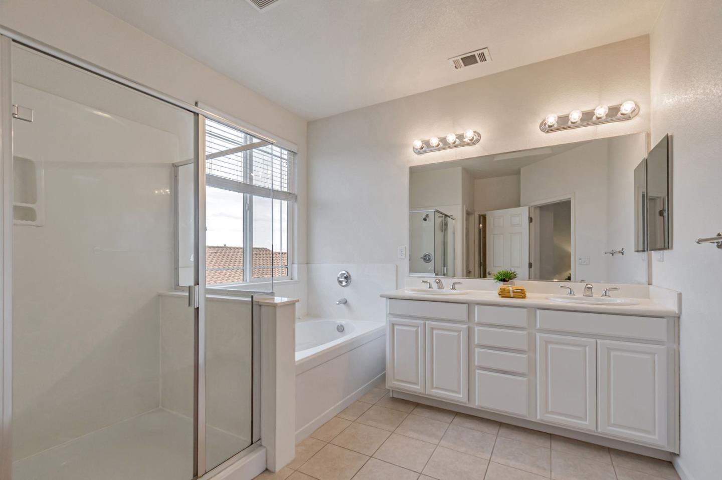1103 Vida Larga Loop Milpitas, CA 95035 - Photo 31 of 44 a spacious bathroom with a double vanity sink a mirror and a bathtub