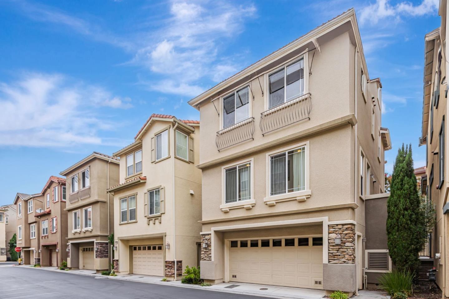 1103 Vida Larga Loop Milpitas, CA 95035 - Photo 36 of 44 a front view of a residential apartment building with a yard