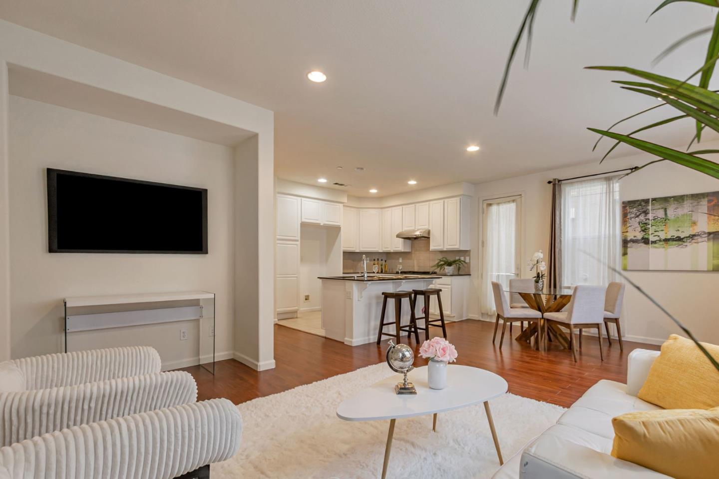 1103 Vida Larga Loop Milpitas, CA 95035 - Photo 7 of 44 a living room with furniture a flat screen tv and kitchen view