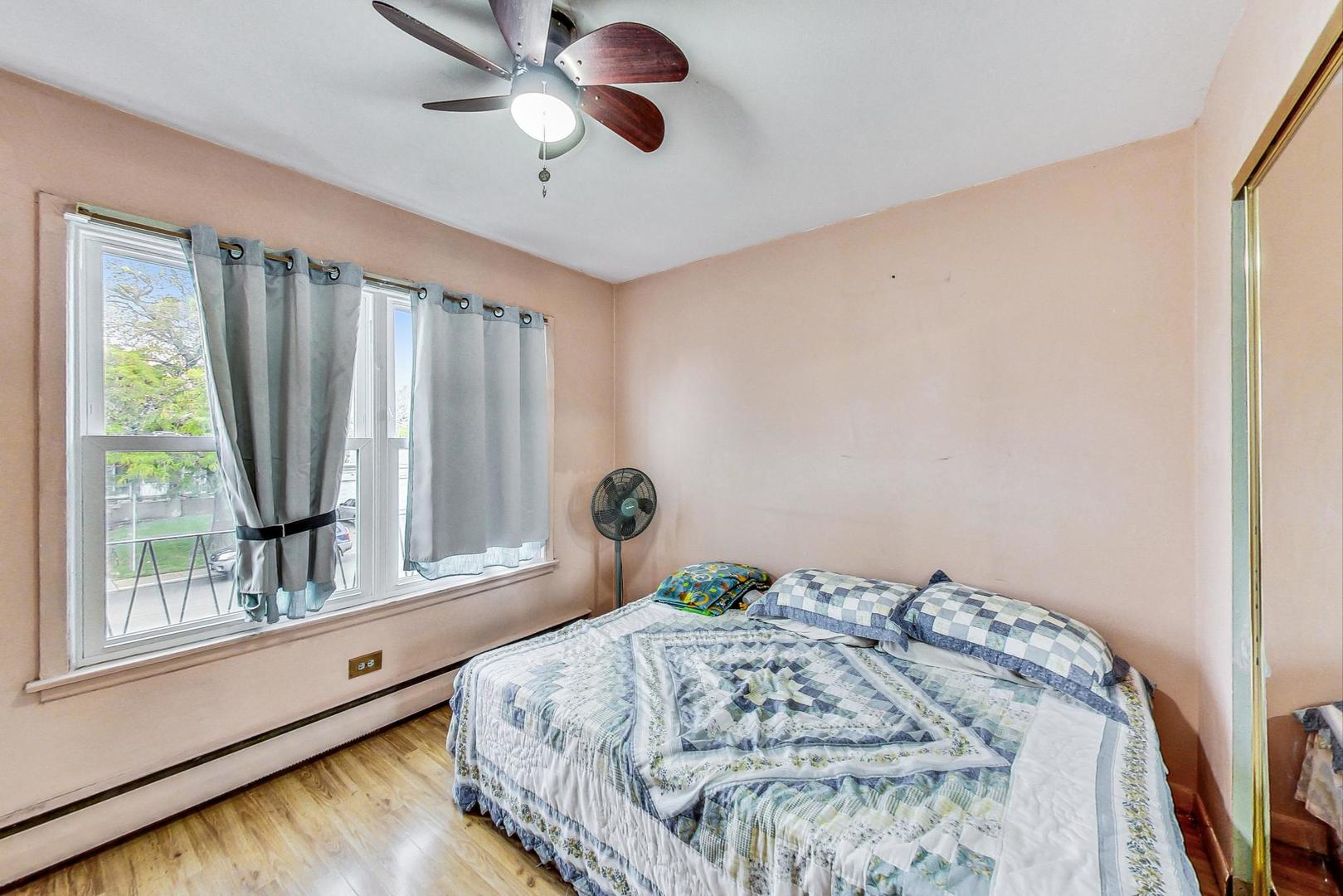 8803 Robin Drive Des Plaines, IL 60016 - Photo 12 of 18 a bedroom with a bed and a window