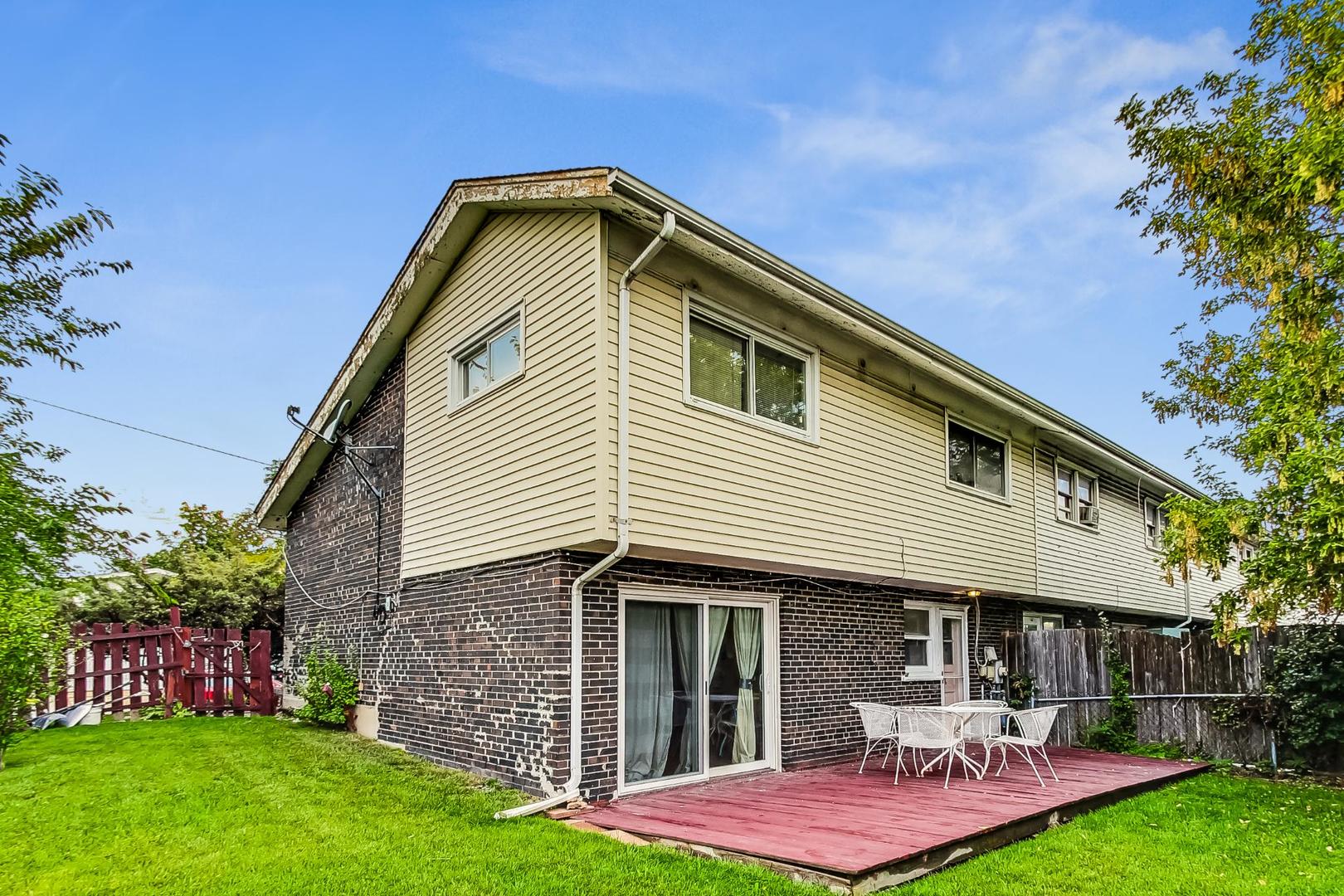 8803 Robin Drive Des Plaines, IL 60016 - Photo 16 of 18 a front view of a house with garden