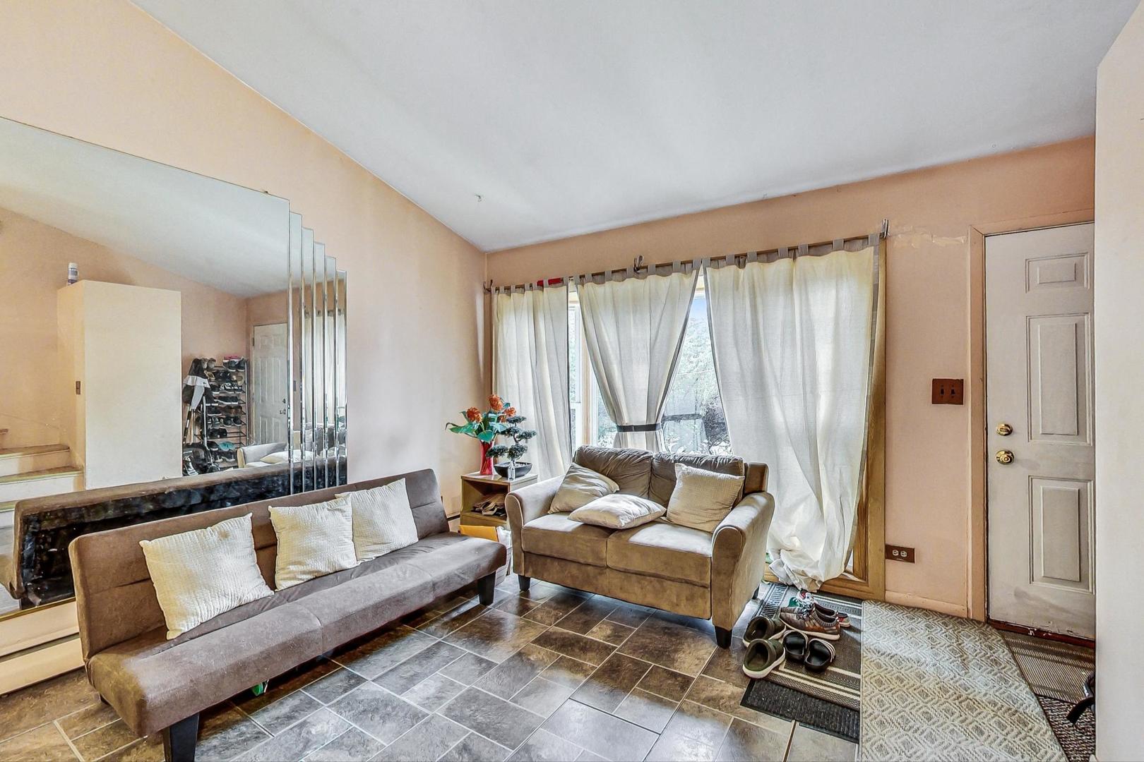 8803 Robin Drive Des Plaines, IL 60016 - Photo 2 of 18 a living room with furniture and a window