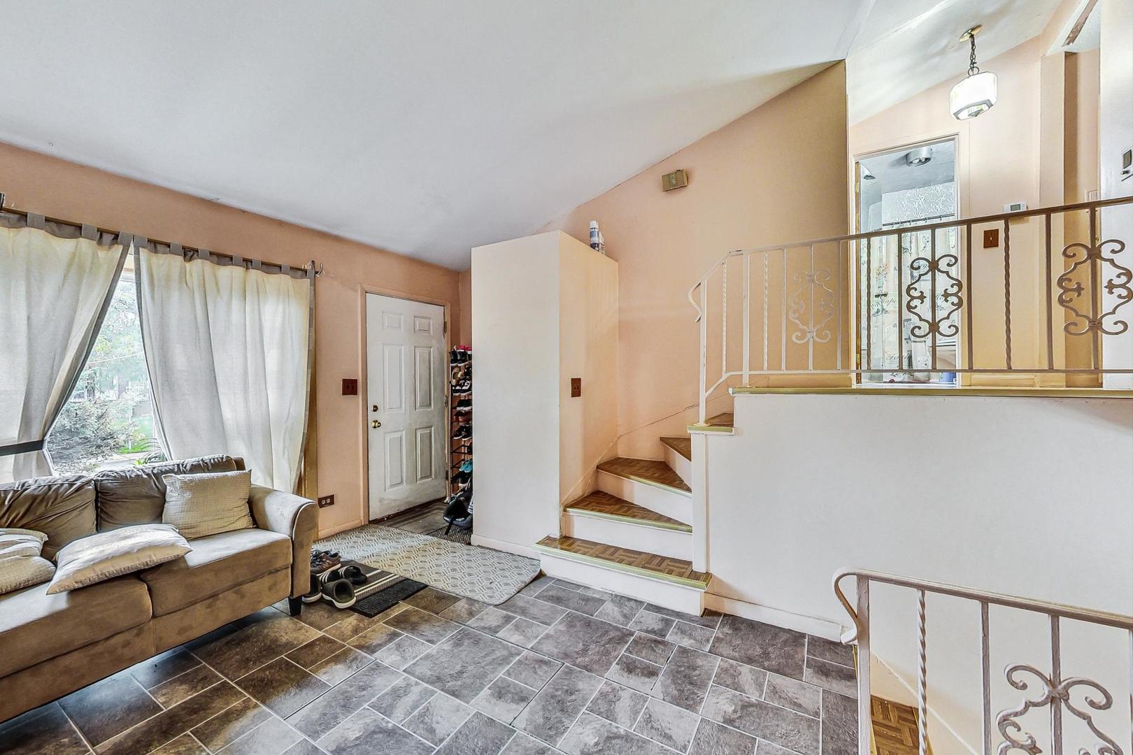 8803 Robin Drive Des Plaines, IL 60016 - Photo 3 of 18 a living room with furniture a large window and a rug