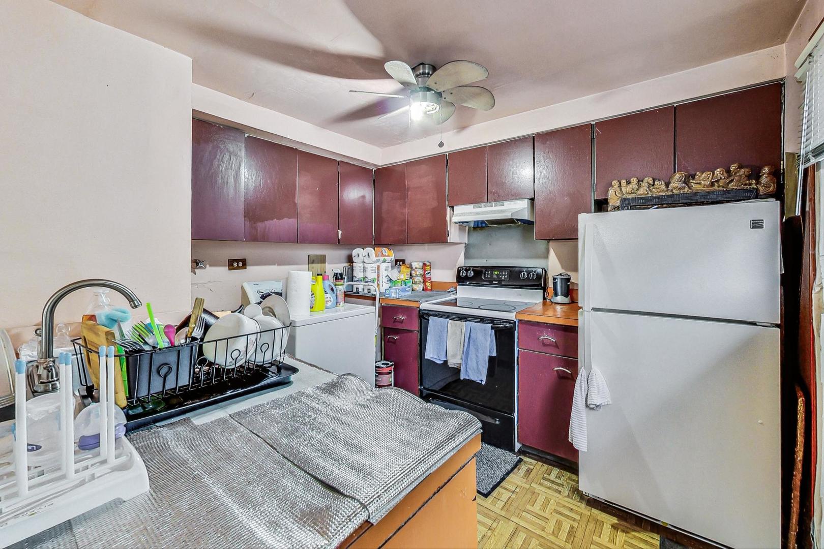 8803 Robin Drive Des Plaines, IL 60016 - Photo 7 of 18 a kitchen with refrigerator and cabinets