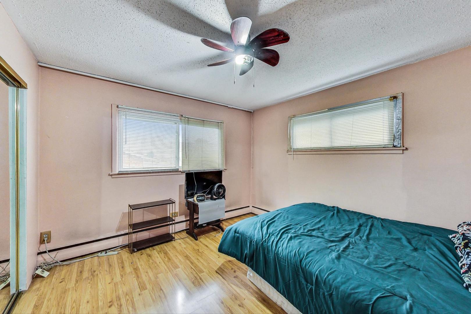 8803 Robin Drive Des Plaines, IL 60016 - Photo 10 of 18 a bedroom with bed and a window