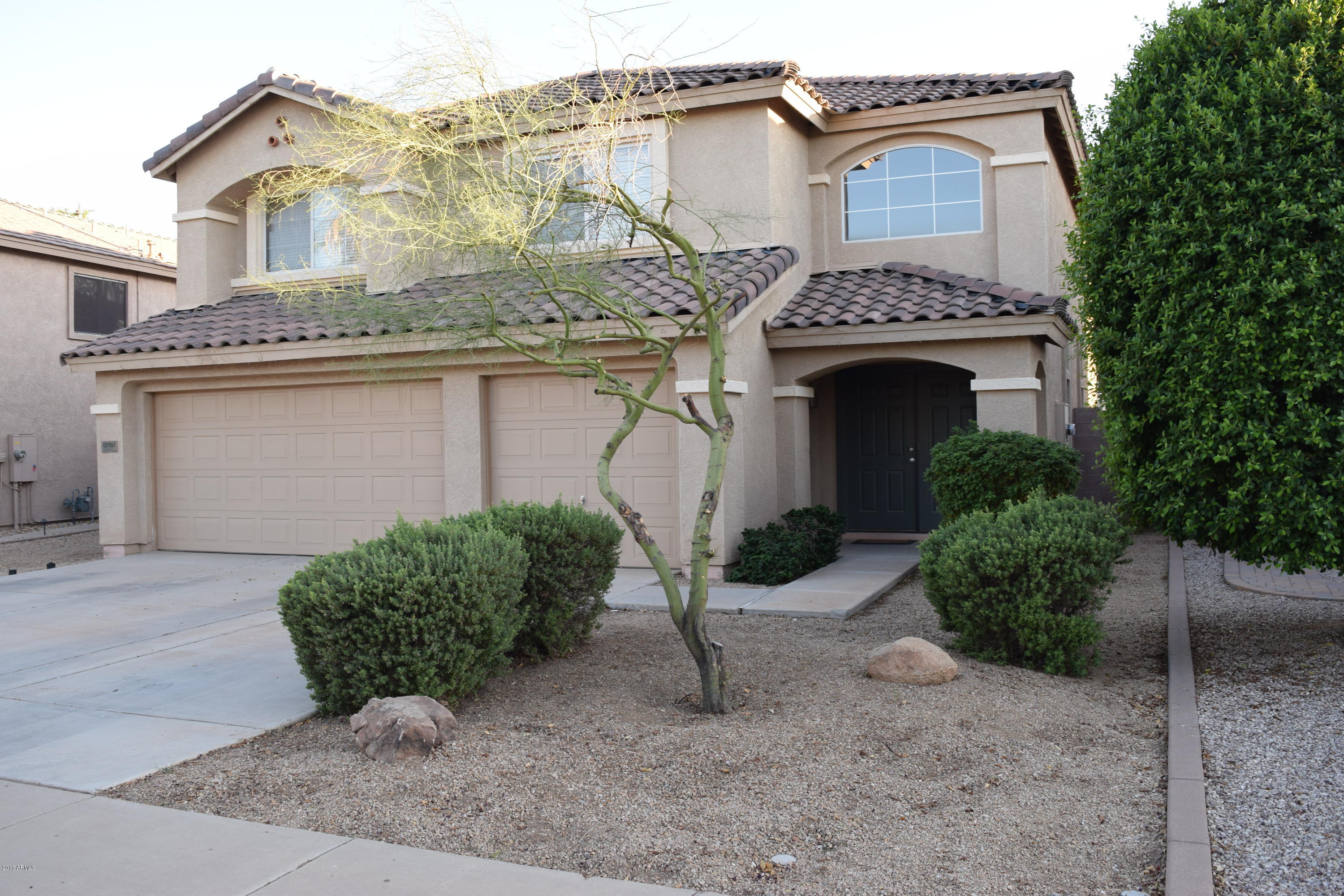 15761 West Calavar Road Surprise, AZ 85379 - Photo 1 of 36 a view of a house with a yard and garage