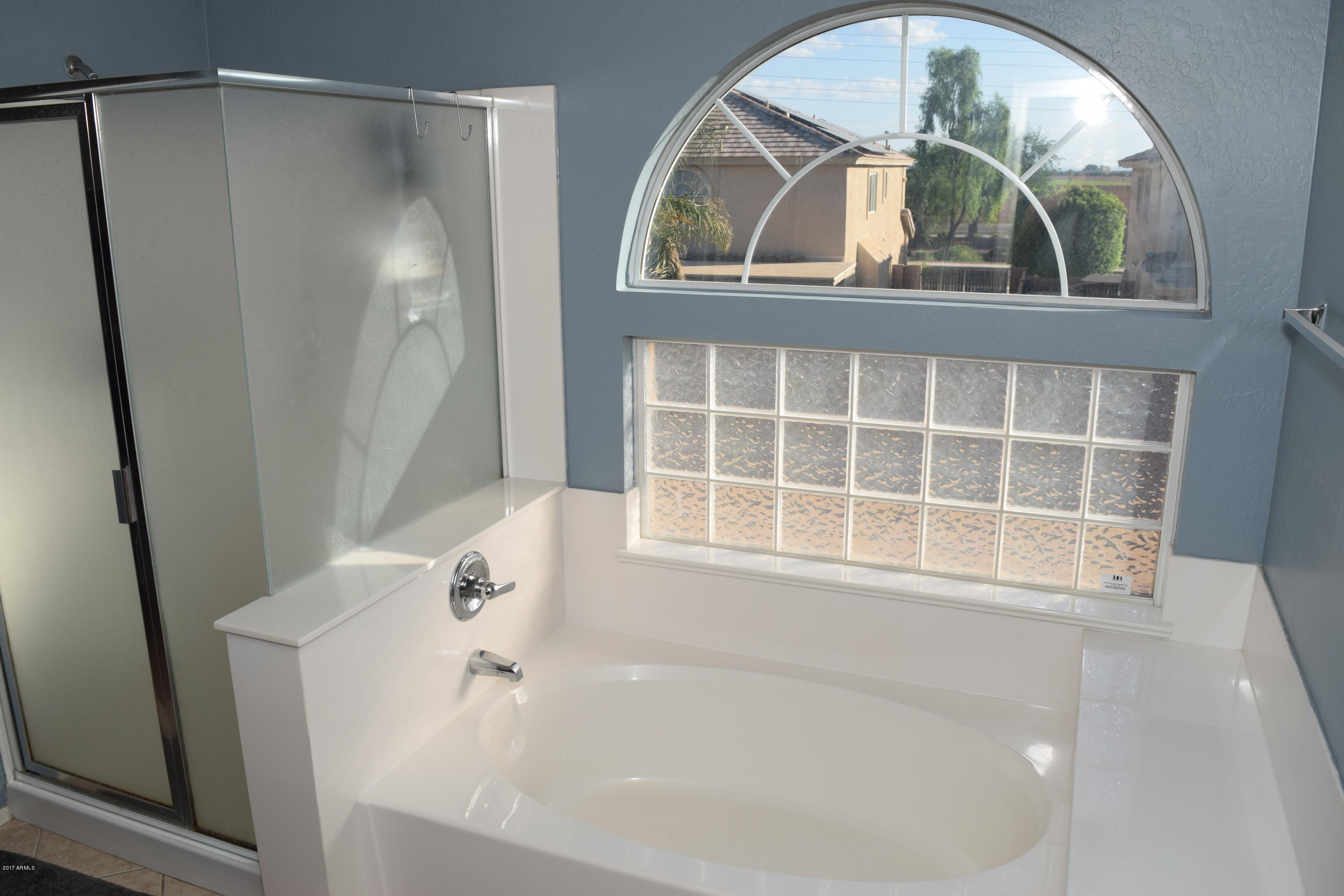 15761 West Calavar Road Surprise, AZ 85379 - Photo 11 of 36 a bathroom with a bathtub and a window