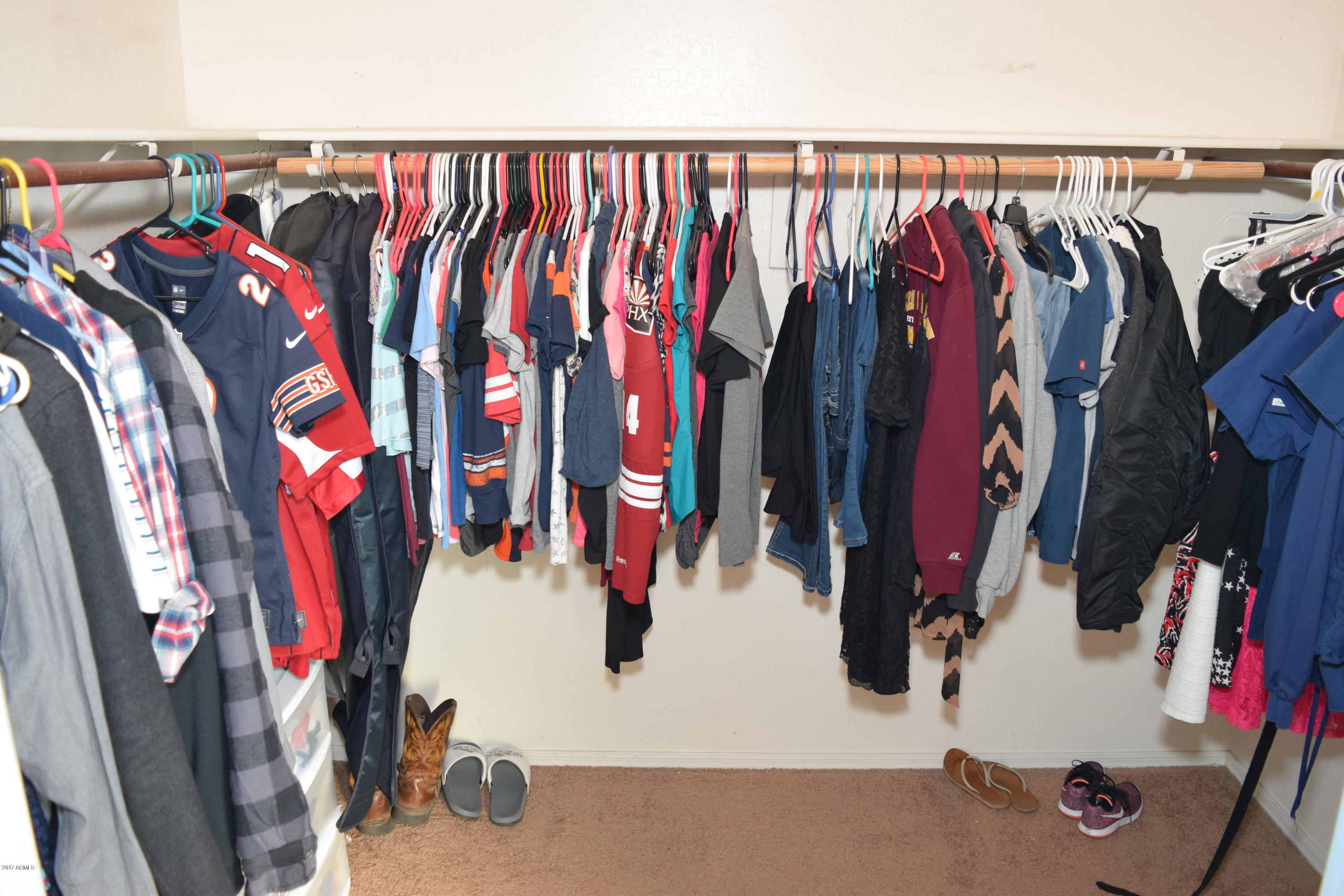 15761 West Calavar Road Surprise, AZ 85379 - Photo 13 of 36 a view of walk in closet with clothes