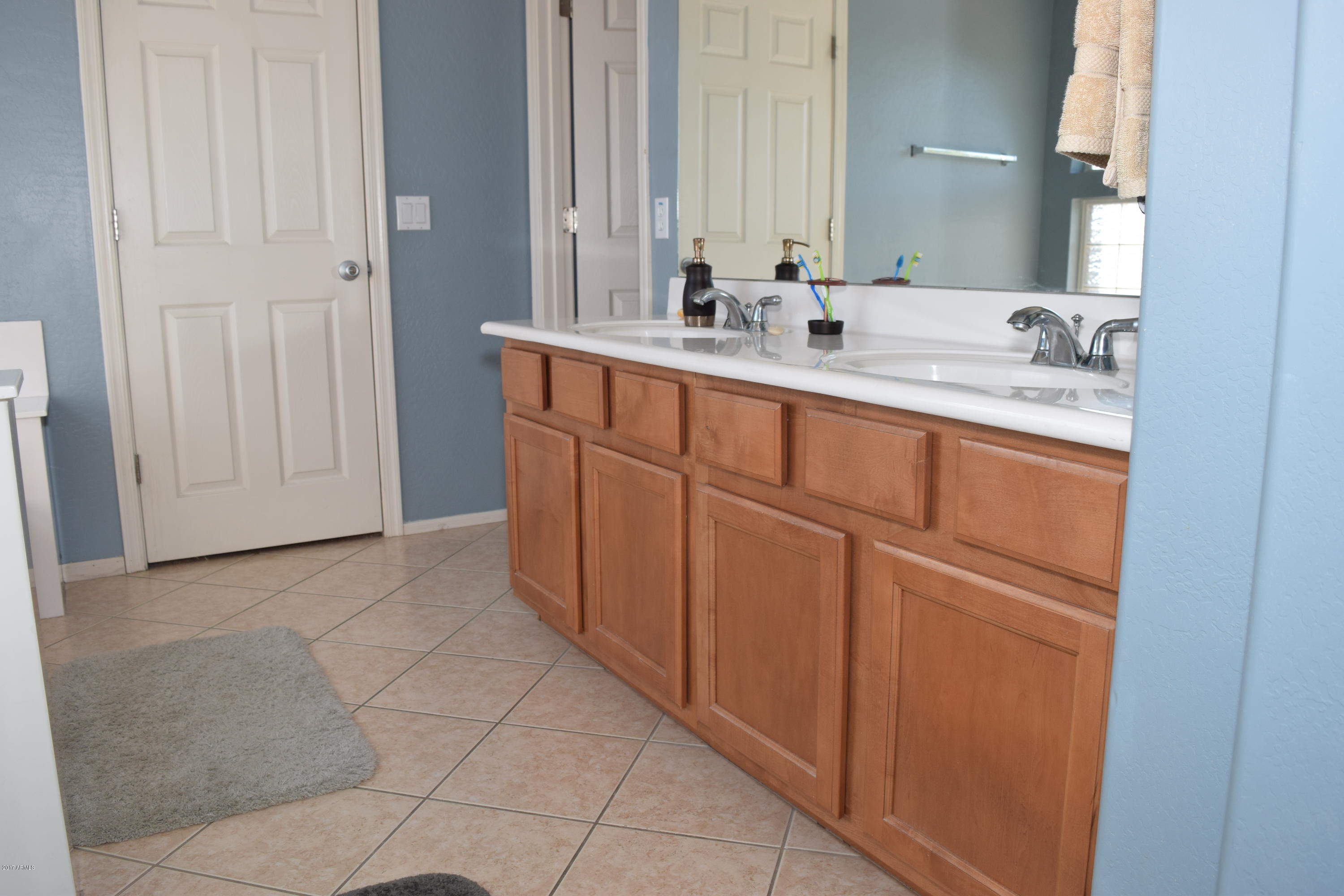 15761 West Calavar Road Surprise, AZ 85379 - Photo 14 of 36 a bathroom with a sink and a mirror