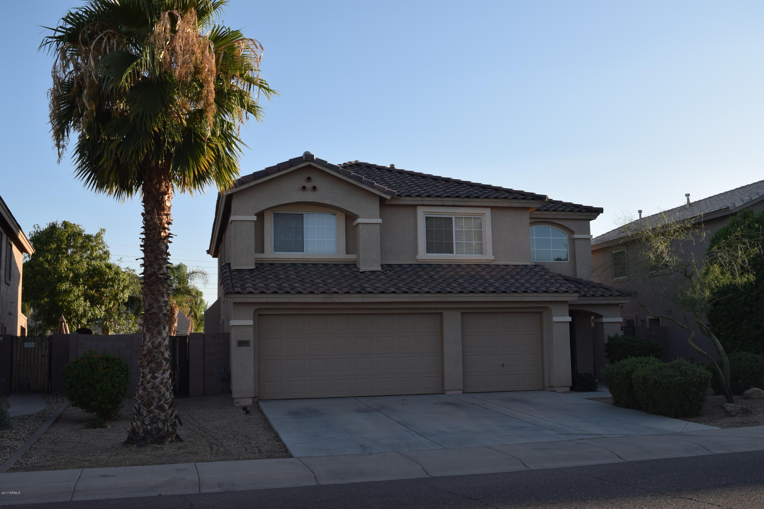 15761 West Calavar Road Surprise, AZ 85379 - Photo 2 of 36 a front view of a house with a garden