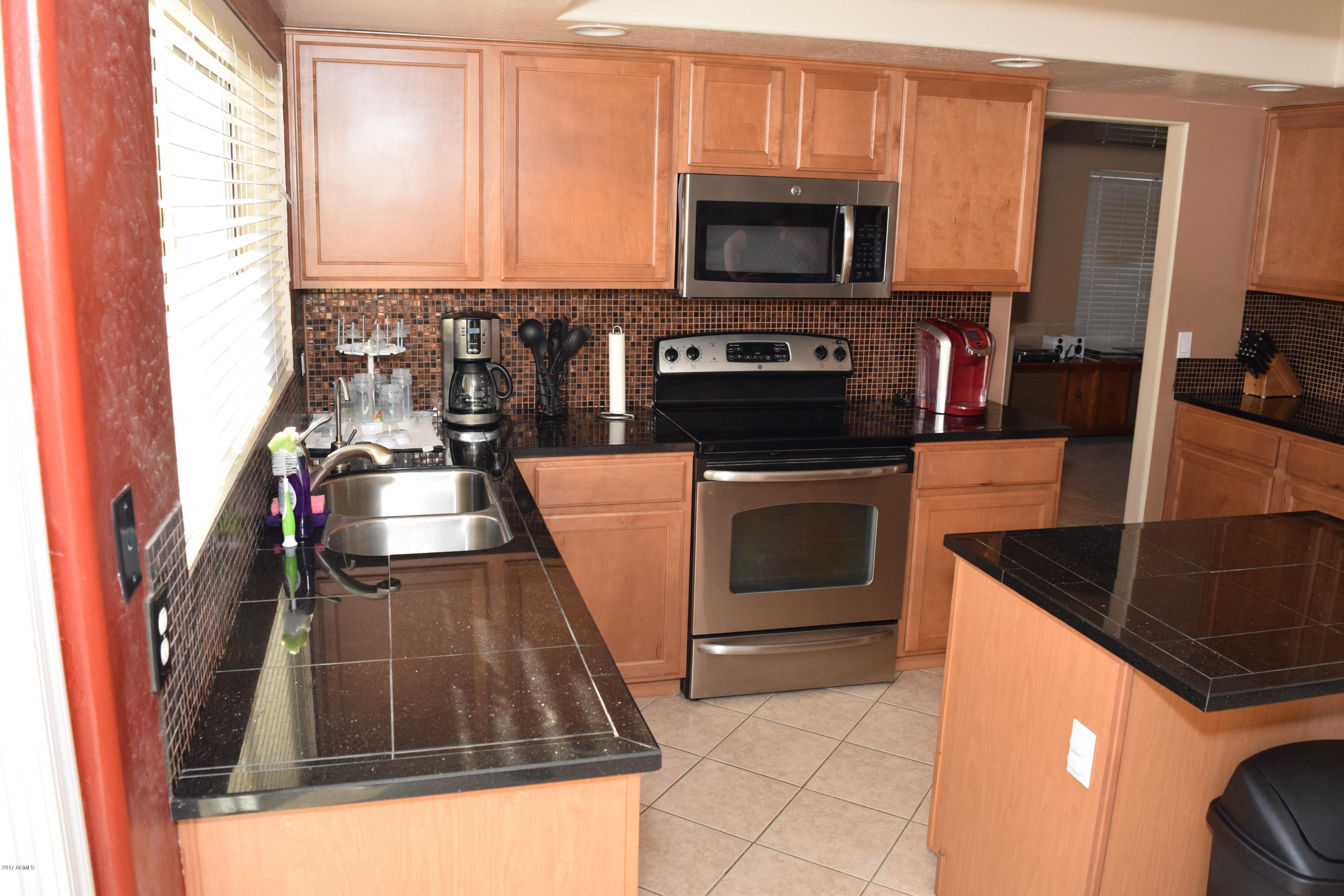 15761 West Calavar Road Surprise, AZ 85379 - Photo 24 of 36 a kitchen with a stove and a microwave