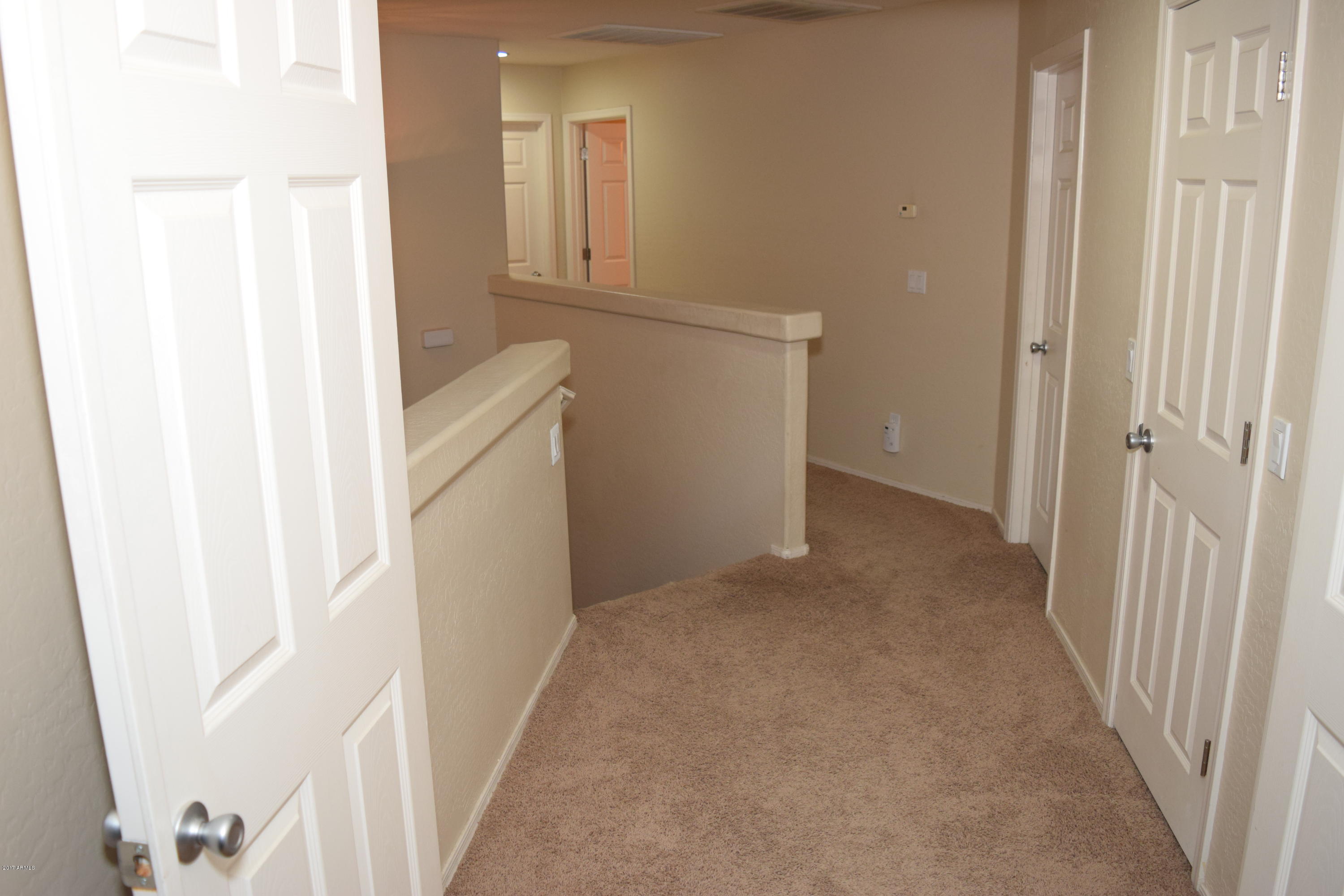 15761 West Calavar Road Surprise, AZ 85379 - Photo 8 of 36 a view of a hallway with washer and dryer