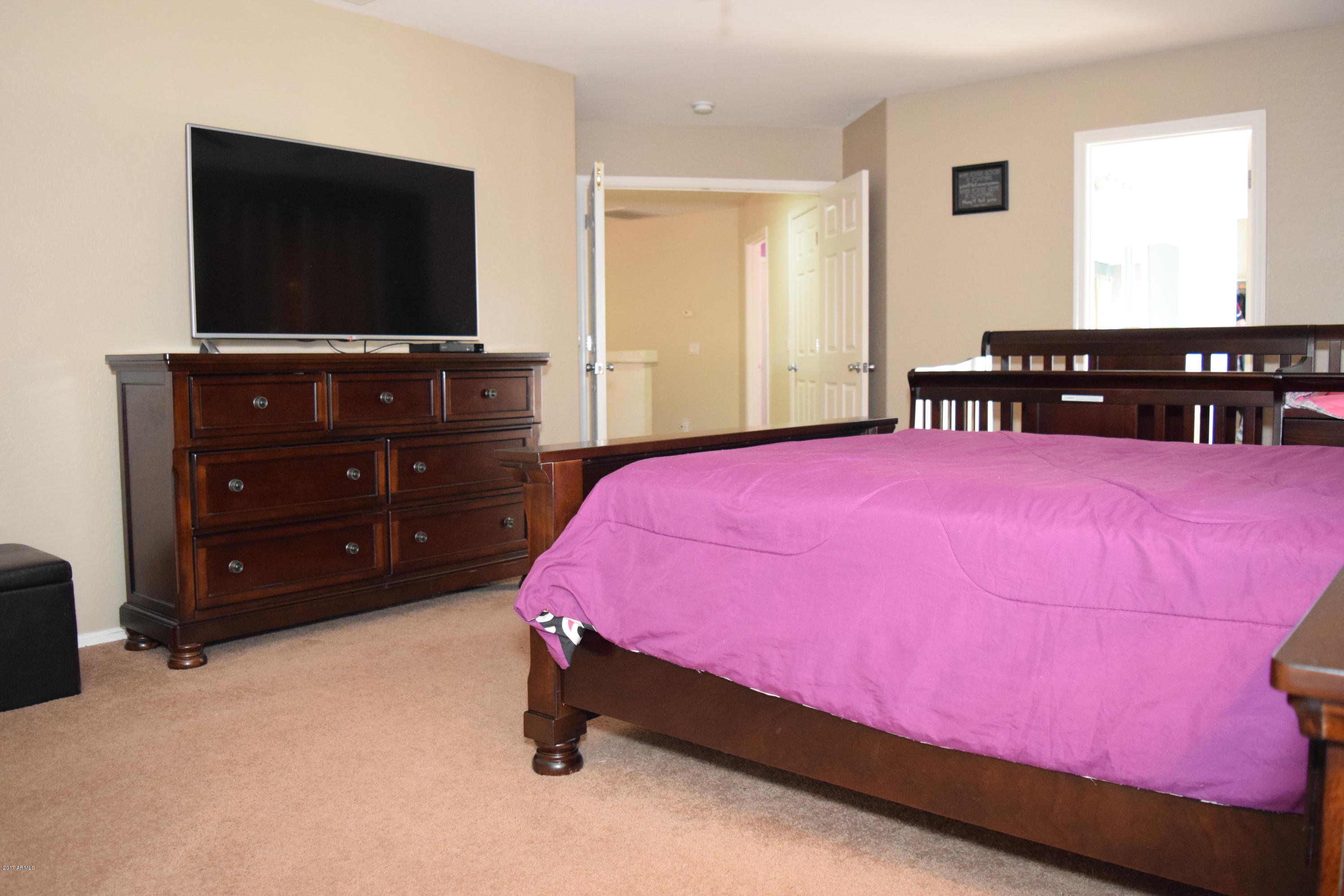 15761 West Calavar Road Surprise, AZ 85379 - Photo 10 of 36 a bedroom with a bed and a flat screen tv