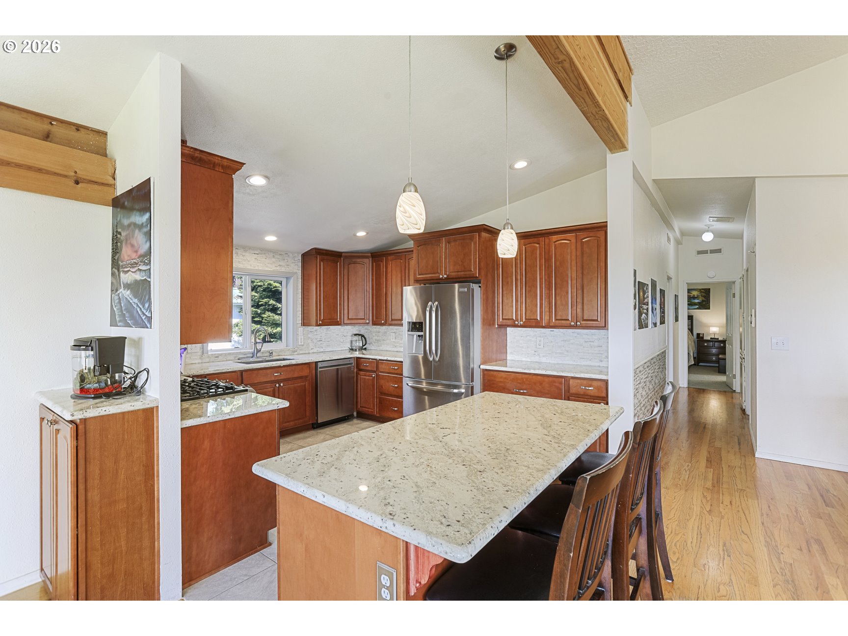 33411 Blaha Road Warren, OR 97053 - Photo 13 of 48 a kitchen with stainless steel appliances kitchen island granite countertop a table and chairs in it