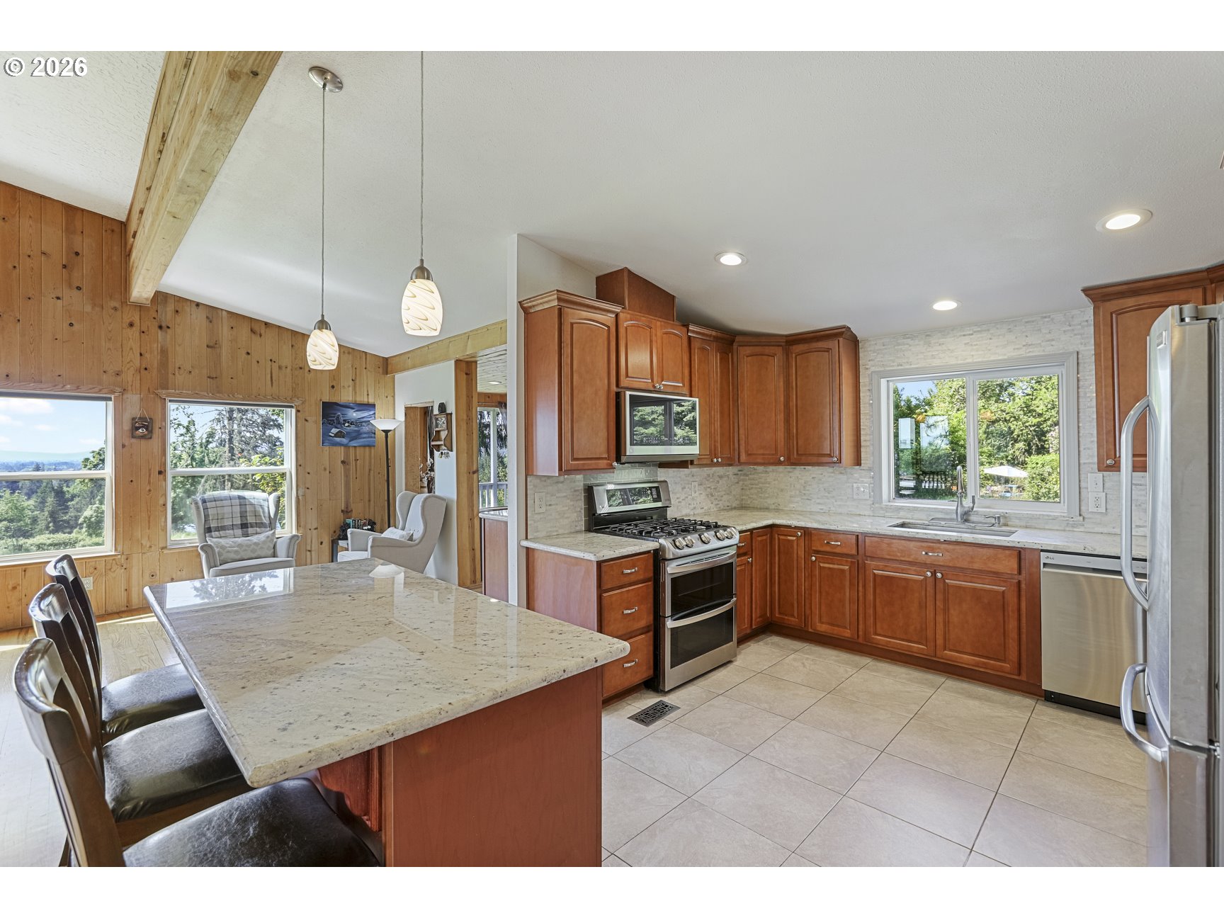 33411 Blaha Road Warren, OR 97053 - Photo 14 of 48 a kitchen with stainless steel appliances granite countertop a stove a sink a microwave a dining table and chairs