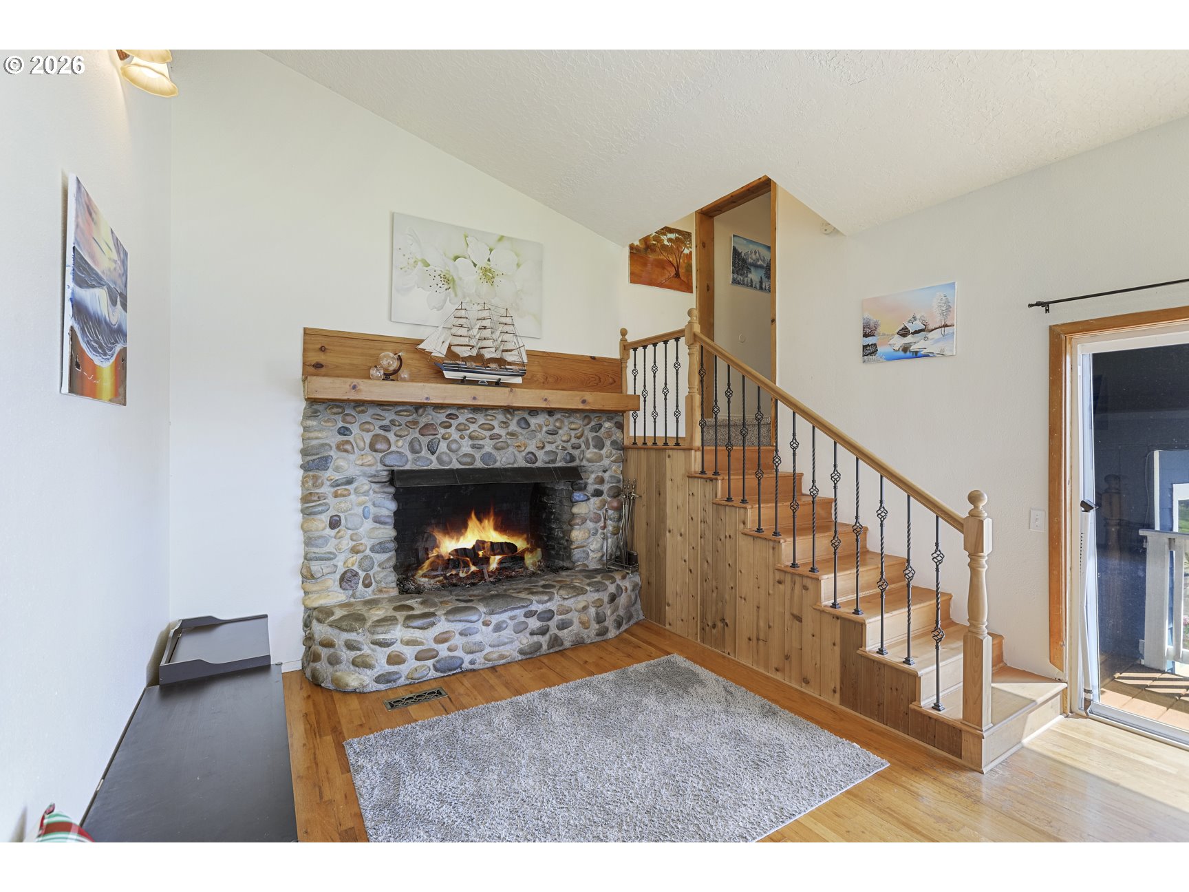 33411 Blaha Road Warren, OR 97053 - Photo 9 of 48 a living room with furniture and a fireplace
