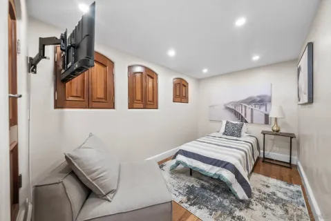 a bedroom with a bed and a night stand