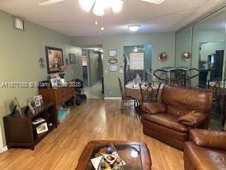 1400 Southwest 124th Terrace, Unit 315Q Pembroke Pines, FL 33027 - Photo 2 of 6 a living room with furniture and wooden floor