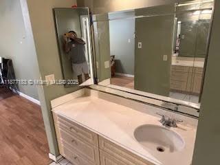 1400 Southwest 124th Terrace, Unit 315Q Pembroke Pines, FL 33027 - Photo 3 of 6 a bathroom with a sink and a mirror