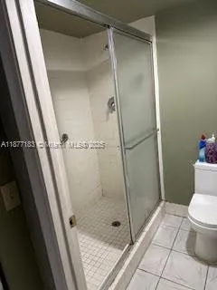 a bathroom with a shower and toilet