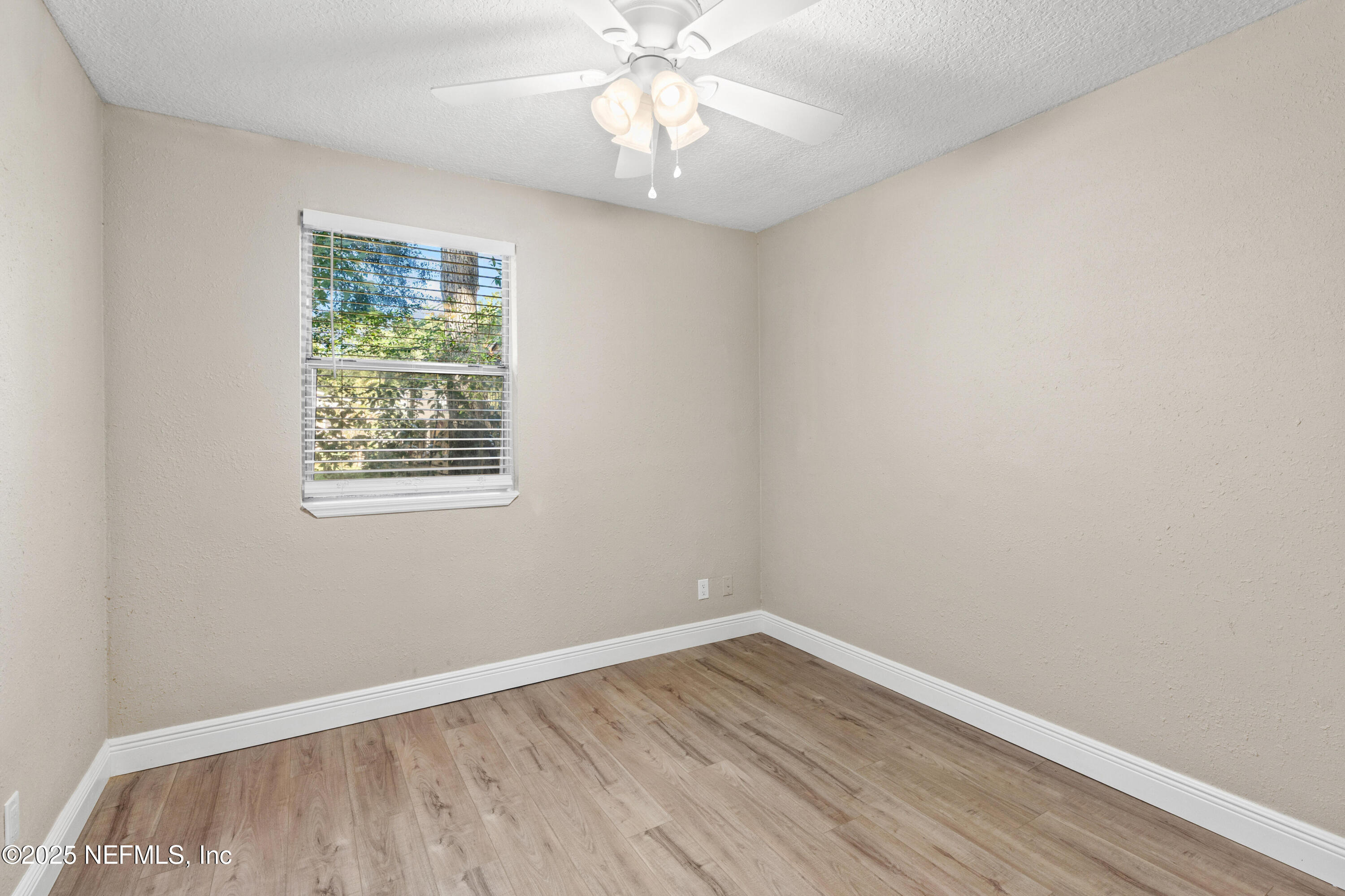 1169 Comanche Street Jacksonville, FL 32205 - Photo 17 of 24 an empty room with a window and wooden floor