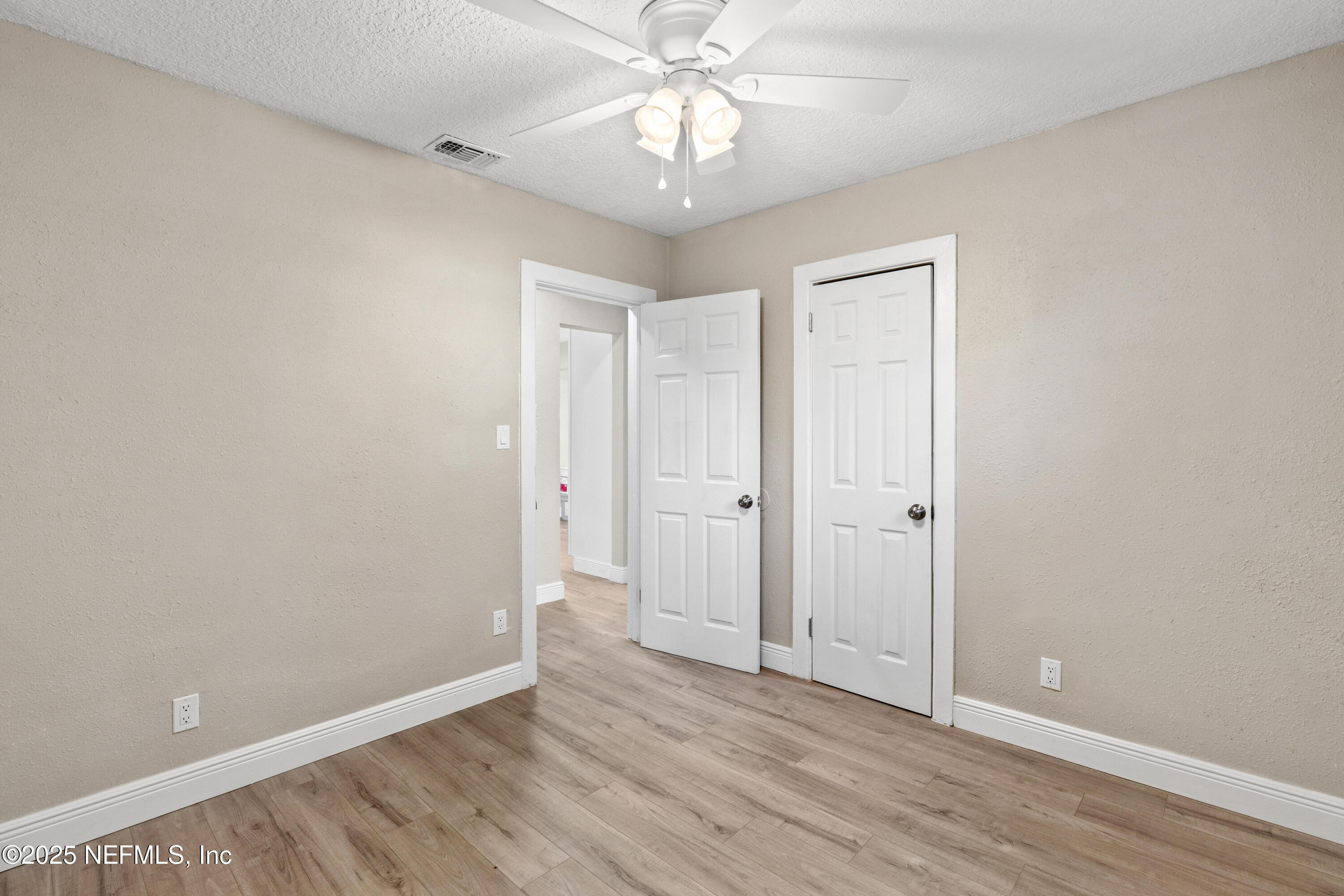 1169 Comanche Street Jacksonville, FL 32205 - Photo 18 of 24 a view of an empty room with chandelier fan and wooden floor