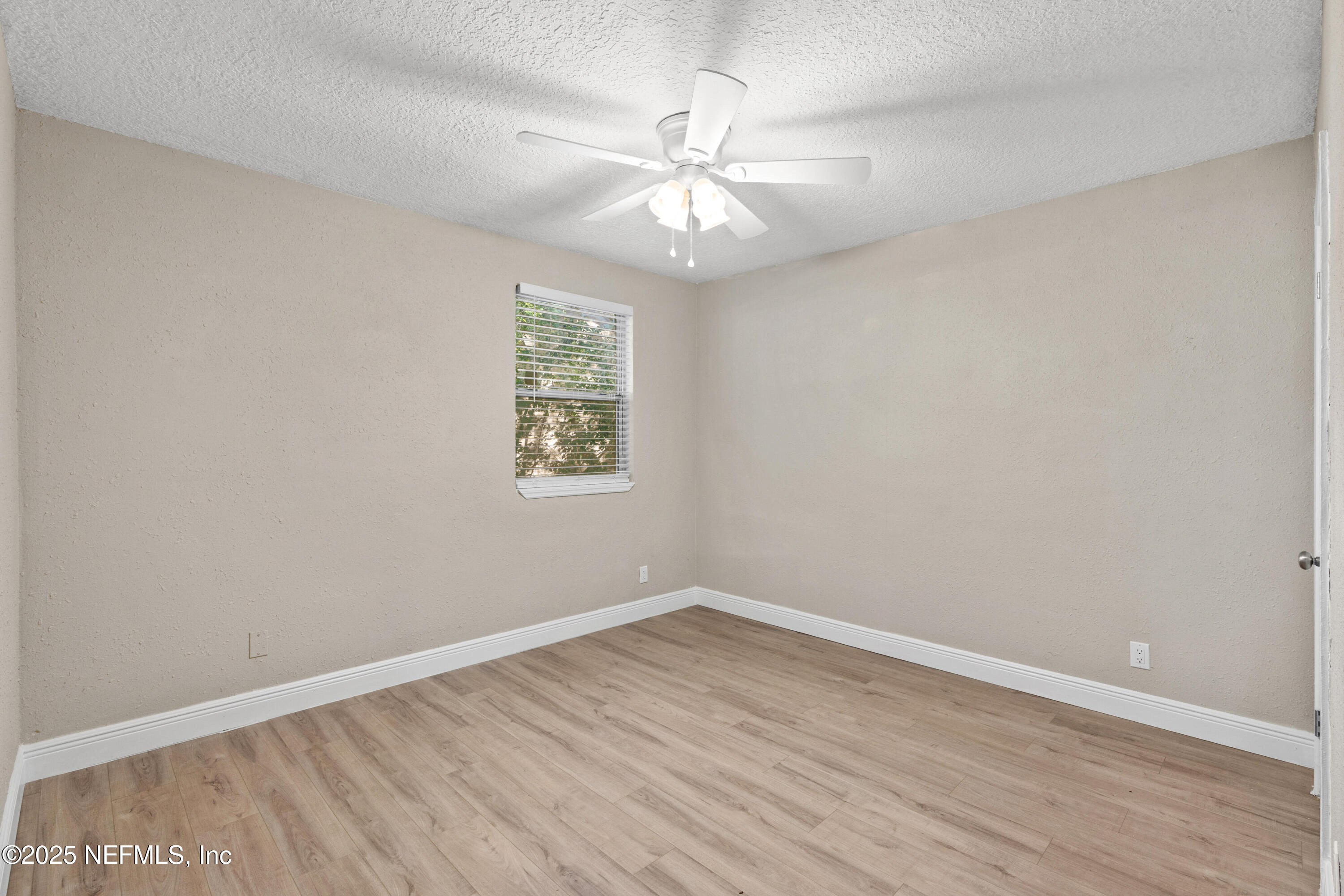 1169 Comanche Street Jacksonville, FL 32205 - Photo 19 of 24 wooden floor in an empty room with a window