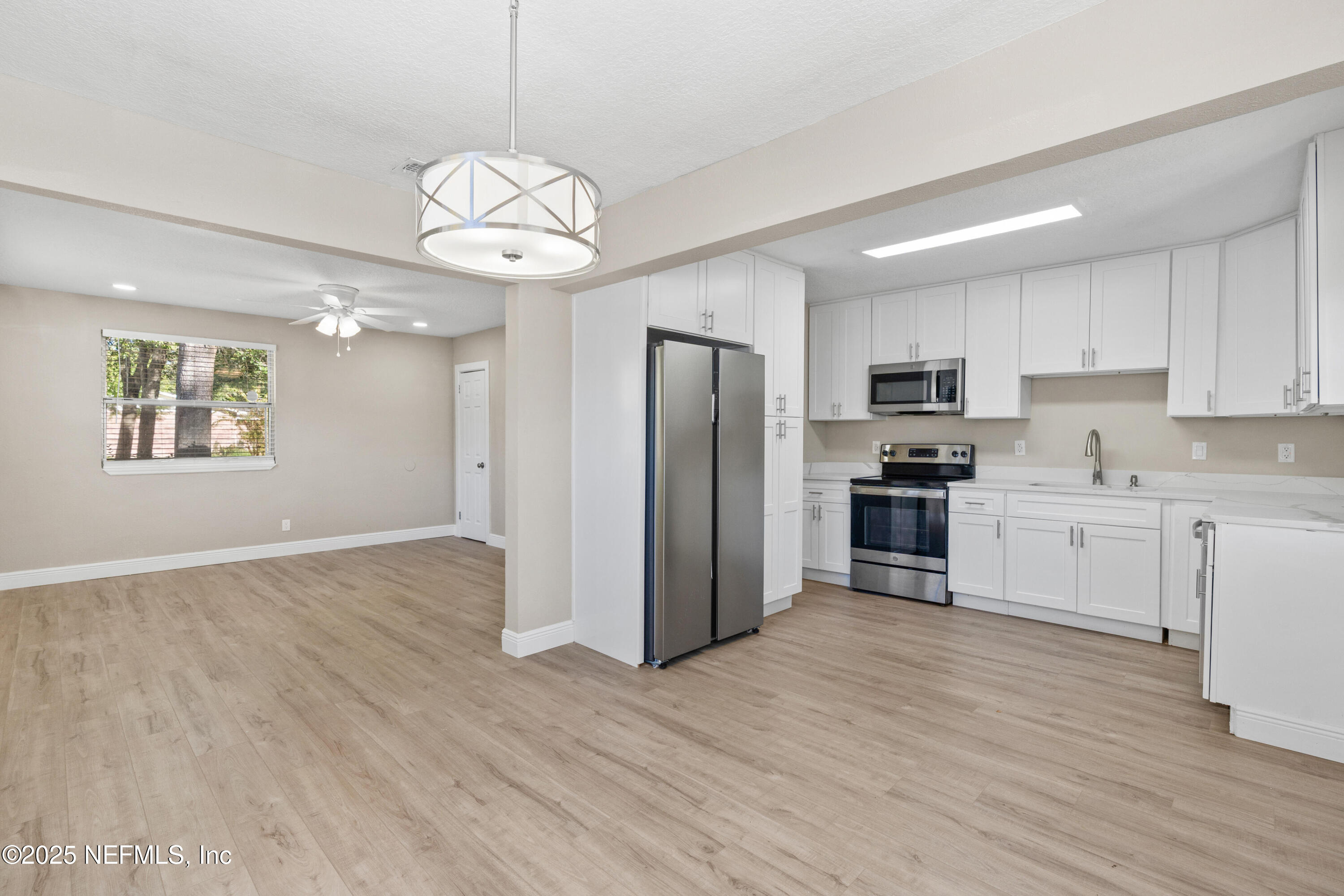 1169 Comanche Street Jacksonville, FL 32205 - Photo 9 of 24 a kitchen with a refrigerator and cabinets