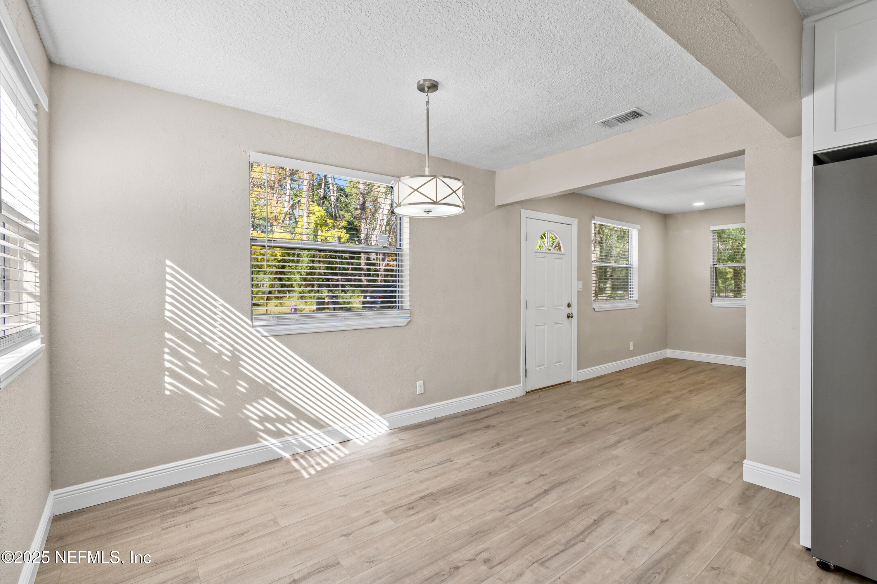 1169 Comanche Street Jacksonville, FL 32205 - Photo 10 of 24 a view of an empty room with wooden floor and a window