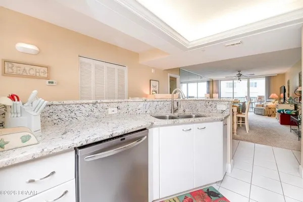 a kitchen with stainless steel appliances a refrigerator sink and microwave