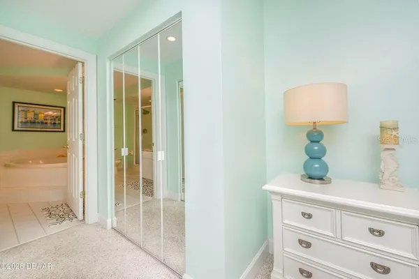 a spacious bathroom with a granite countertop sink a toilet a mirror and bathtub