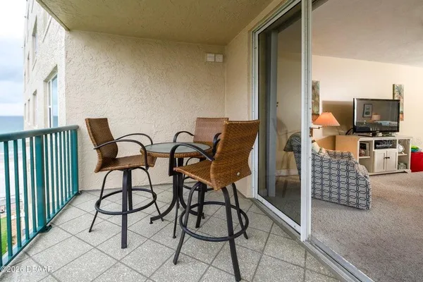 a living room with furniture and a flat screen tv with wooden floor