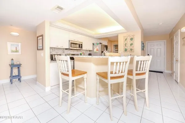 a kitchen with stainless steel appliances granite countertop a sink stove and microwave