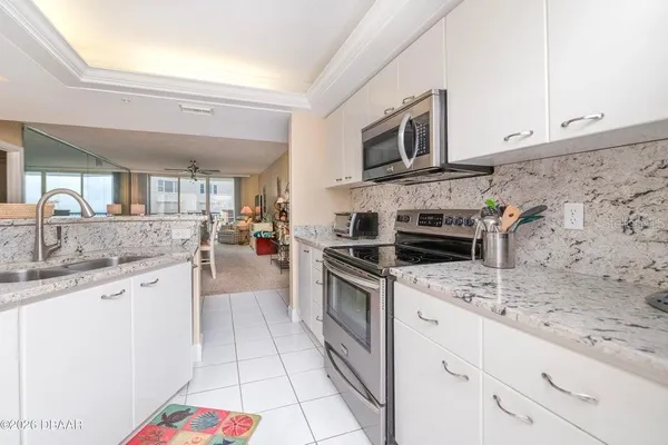 a kitchen with granite countertop a sink and cabinets