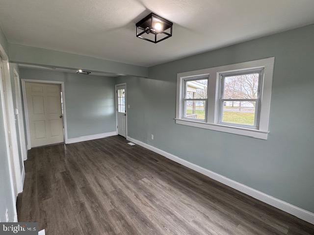 2185 East Wheat Road, Unit D Vineland, NJ 08361 - Photo 13 of 25 a view of an empty room with wooden floor and a window