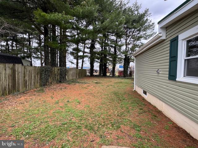2185 East Wheat Road, Unit D Vineland, NJ 08361 - Photo 24 of 25 a backyard of a house with large trees and wooden fence