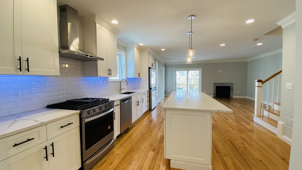 211 West Street, Unit 211 Needham, MA 02494 - Photo 1 of 12 a kitchen with stainless steel appliances granite countertop a stove and a refrigerator