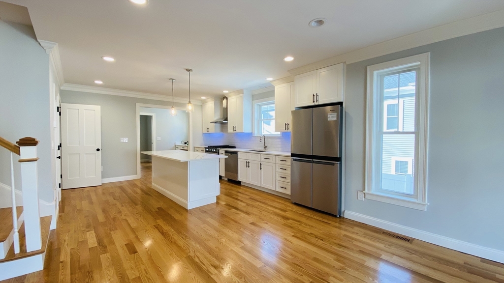 211 West Street, Unit 211 Needham, MA 02494 - Photo 2 of 12 a kitchen with a refrigerator and a stove top oven