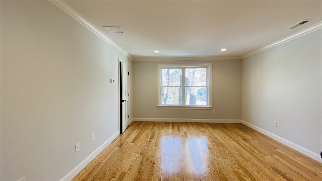 211 West Street, Unit 211 Needham, MA 02494 - Photo 6 of 12 wooden floor in an empty room with a window