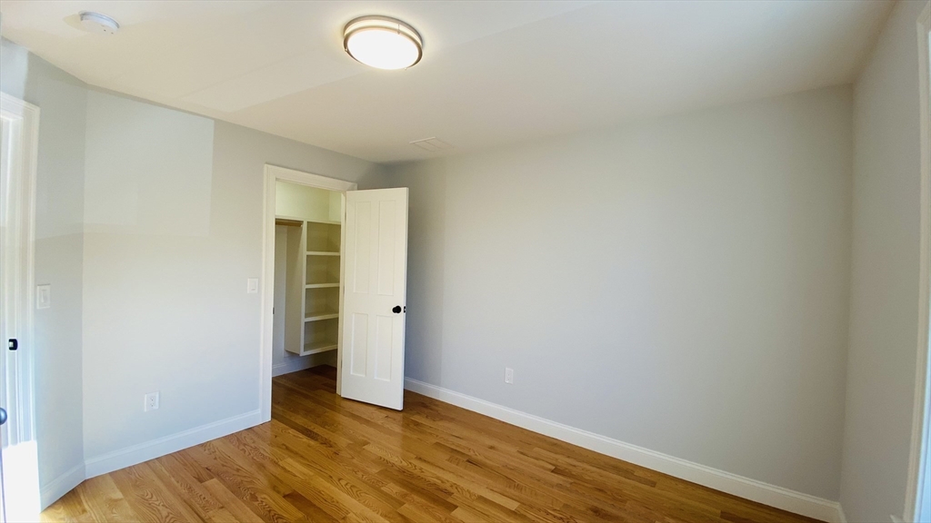 211 West Street, Unit 211 Needham, MA 02494 - Photo 9 of 12 a view of an empty room with wooden floor