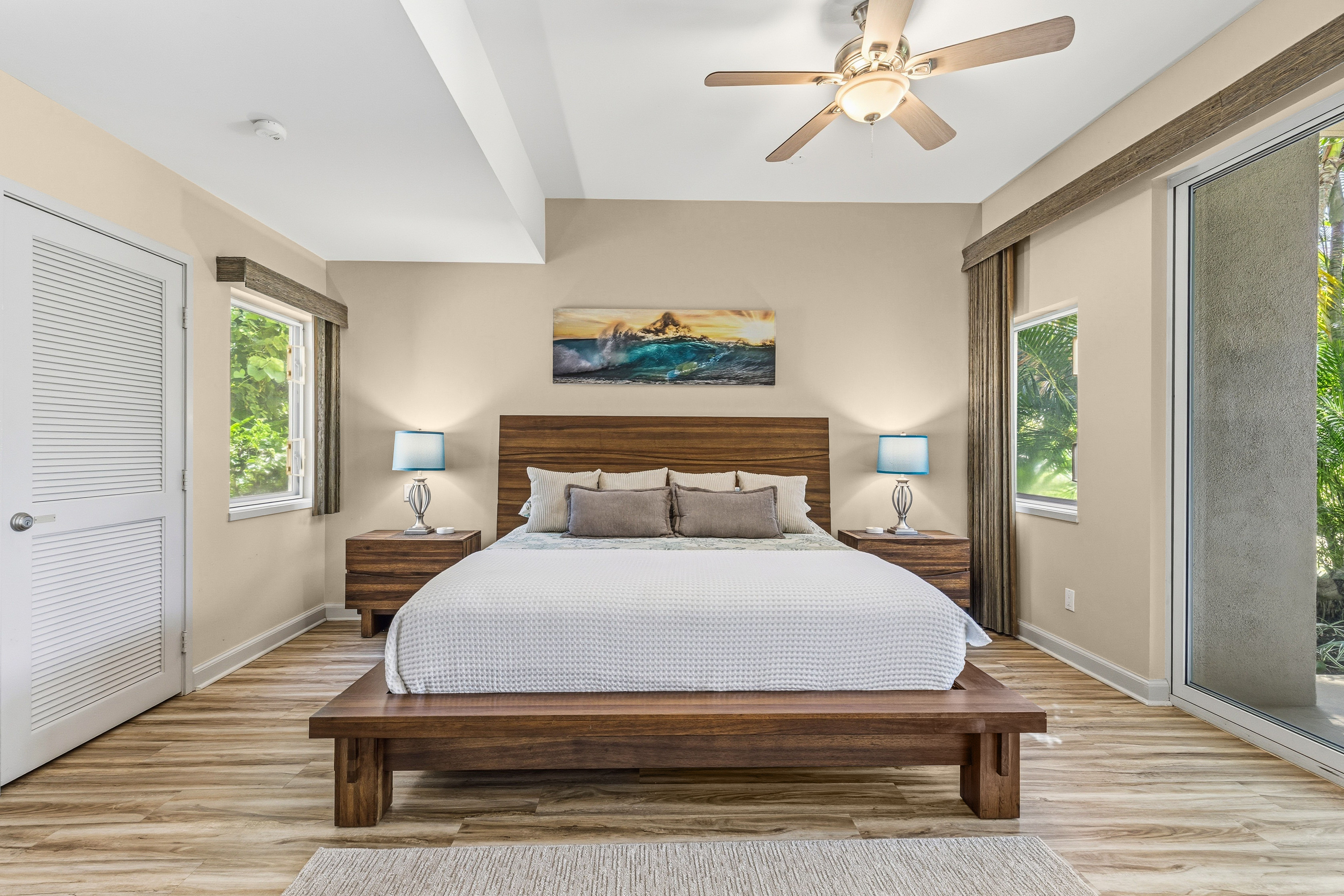 69-1010 Keana Place, Unit B101 Waikoloa, HI 96738 - Photo 13 of 30 a bedroom with a bed and wooden floor