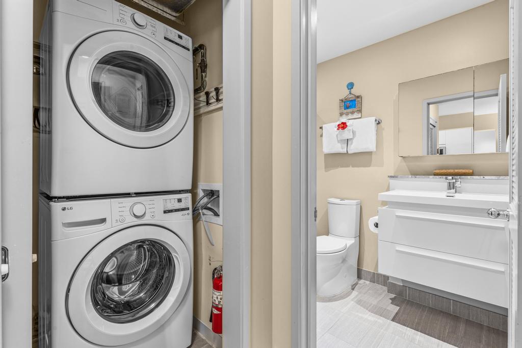 69-1010 Keana Place, Unit B101 Waikoloa, HI 96738 - Photo 17 of 30 a utility room with sink dryer and washer