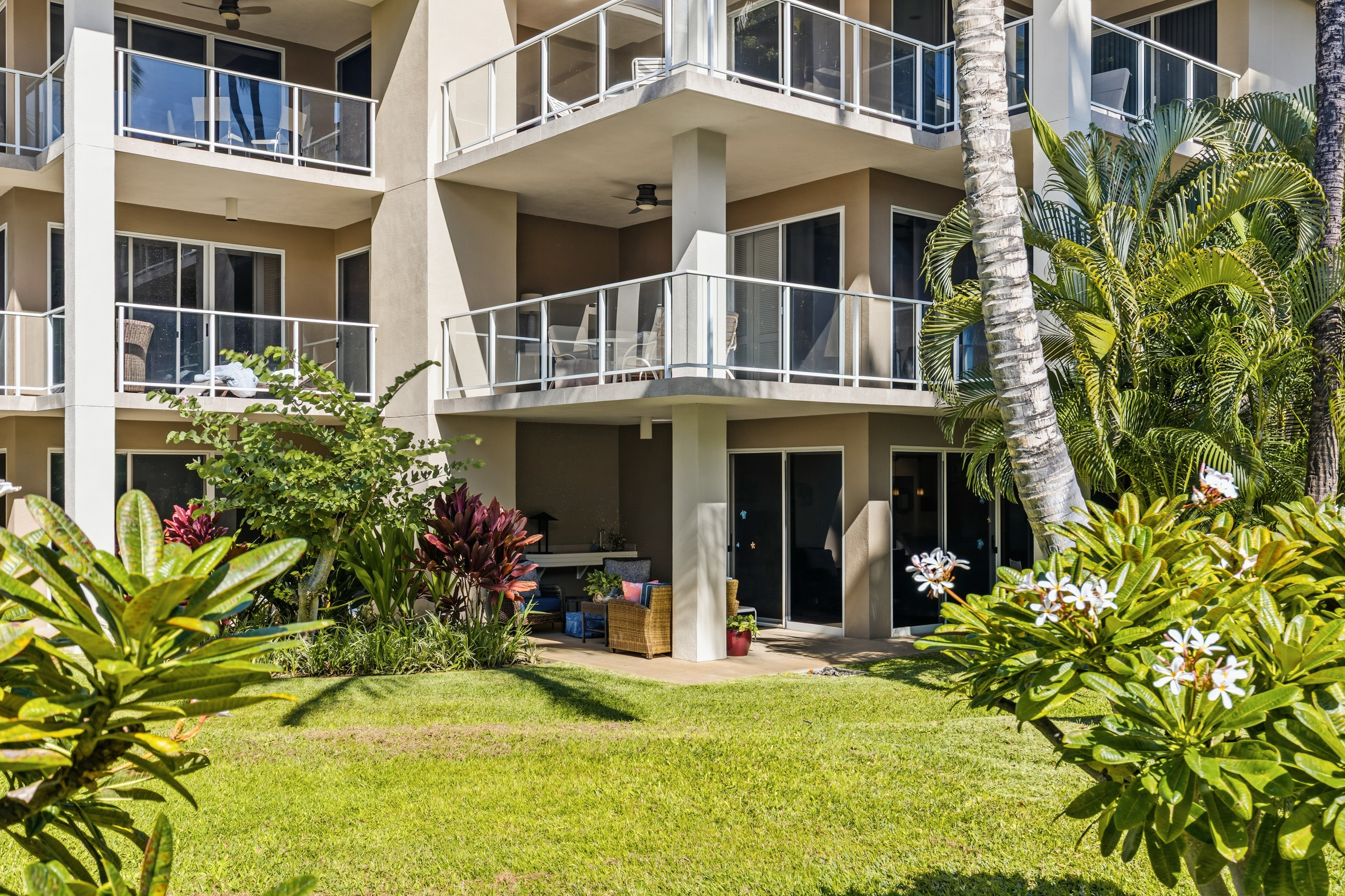 69-1010 Keana Place, Unit B101 Waikoloa, HI 96738 - Photo 19 of 30 a view of a building with potted plants and large trees