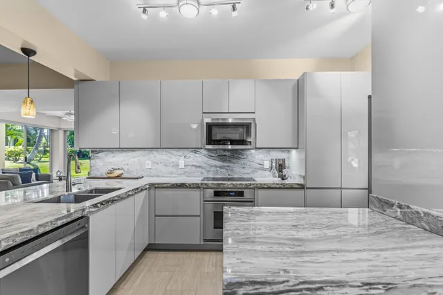 a kitchen with a sink stove and microwave