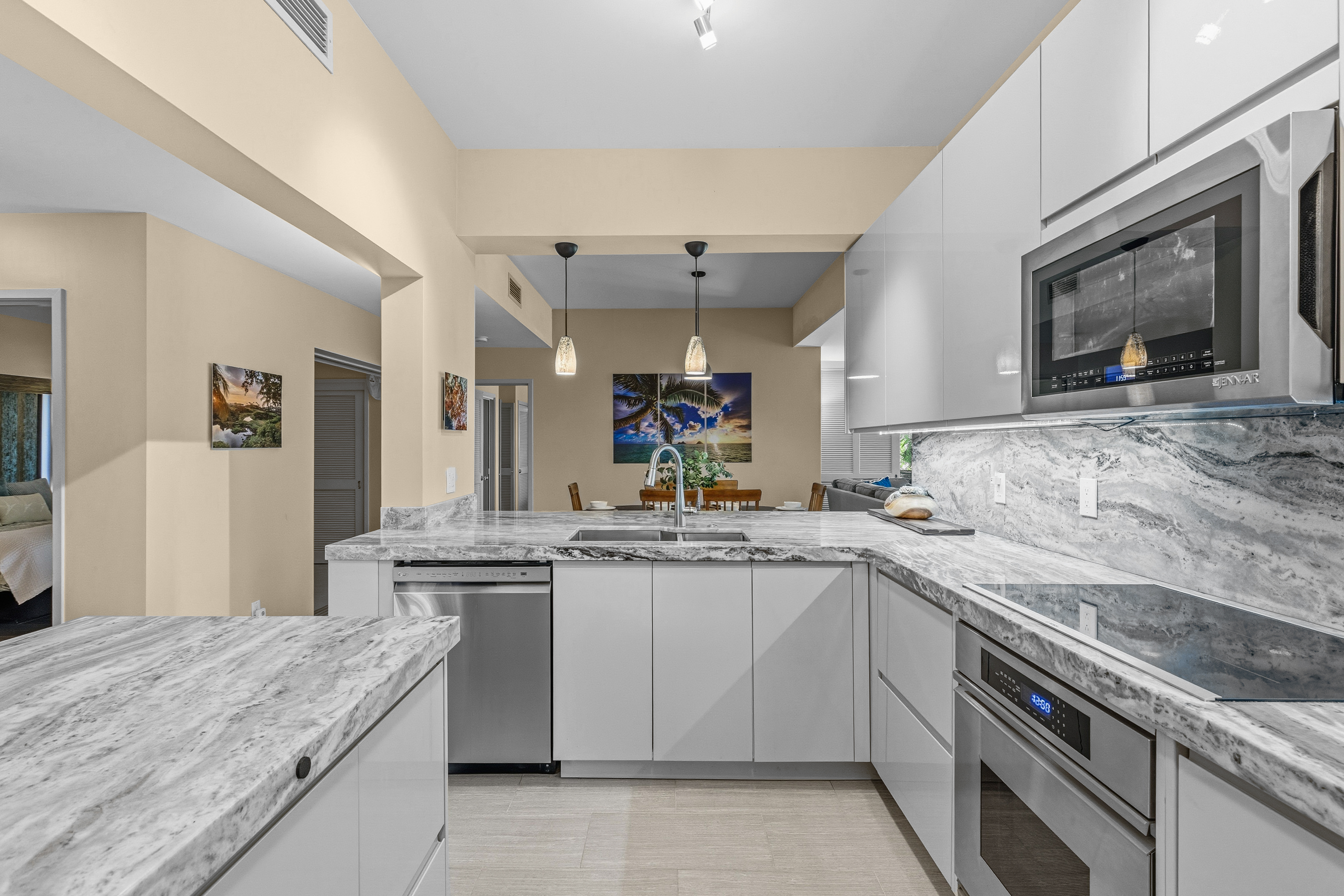 69-1010 Keana Place, Unit B101 Waikoloa, HI 96738 - Photo 5 of 30 a kitchen with a sink stove and cabinets