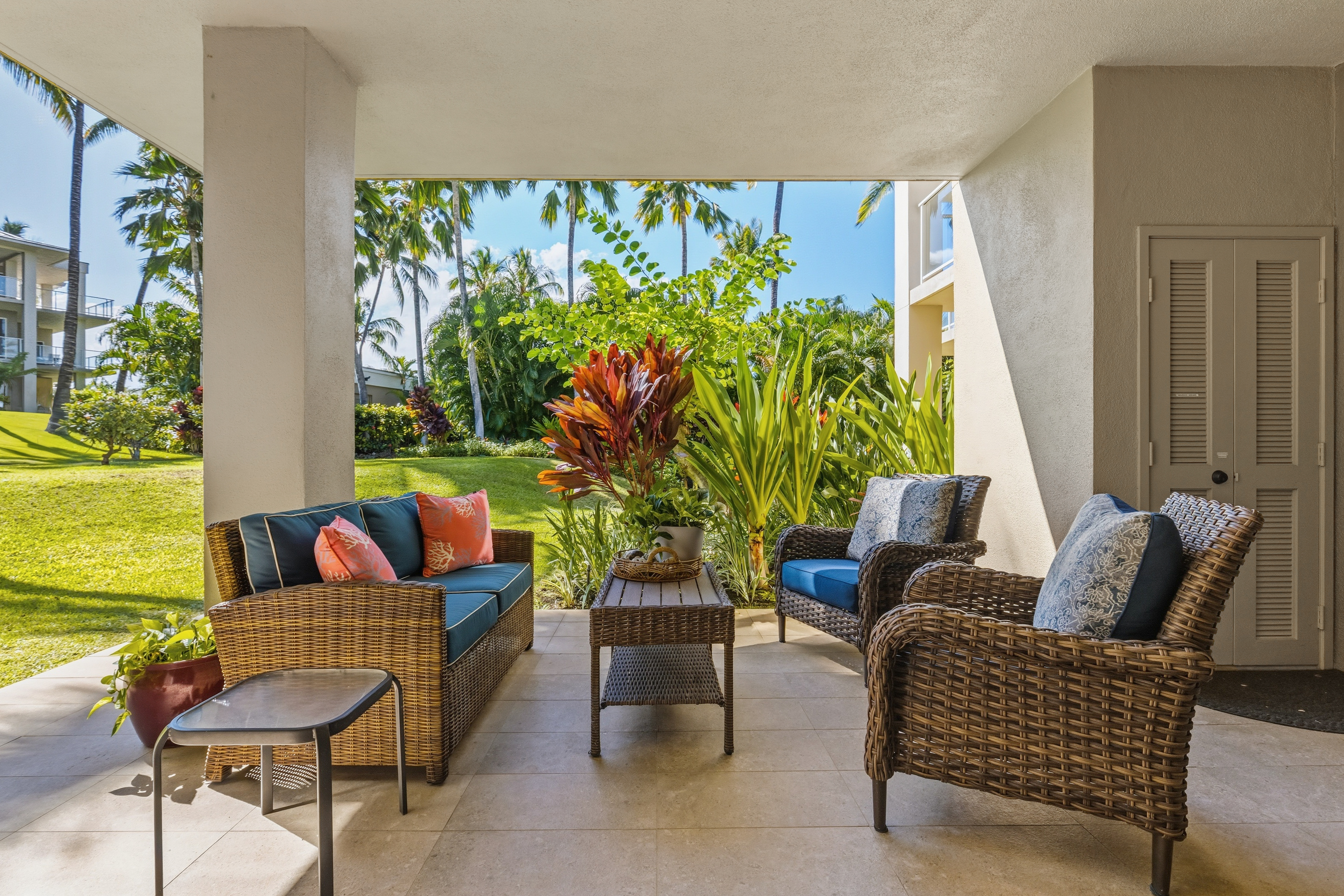 69-1010 Keana Place, Unit B101 Waikoloa, HI 96738 - Photo 9 of 30 a living room with patio furniture and a potted plant